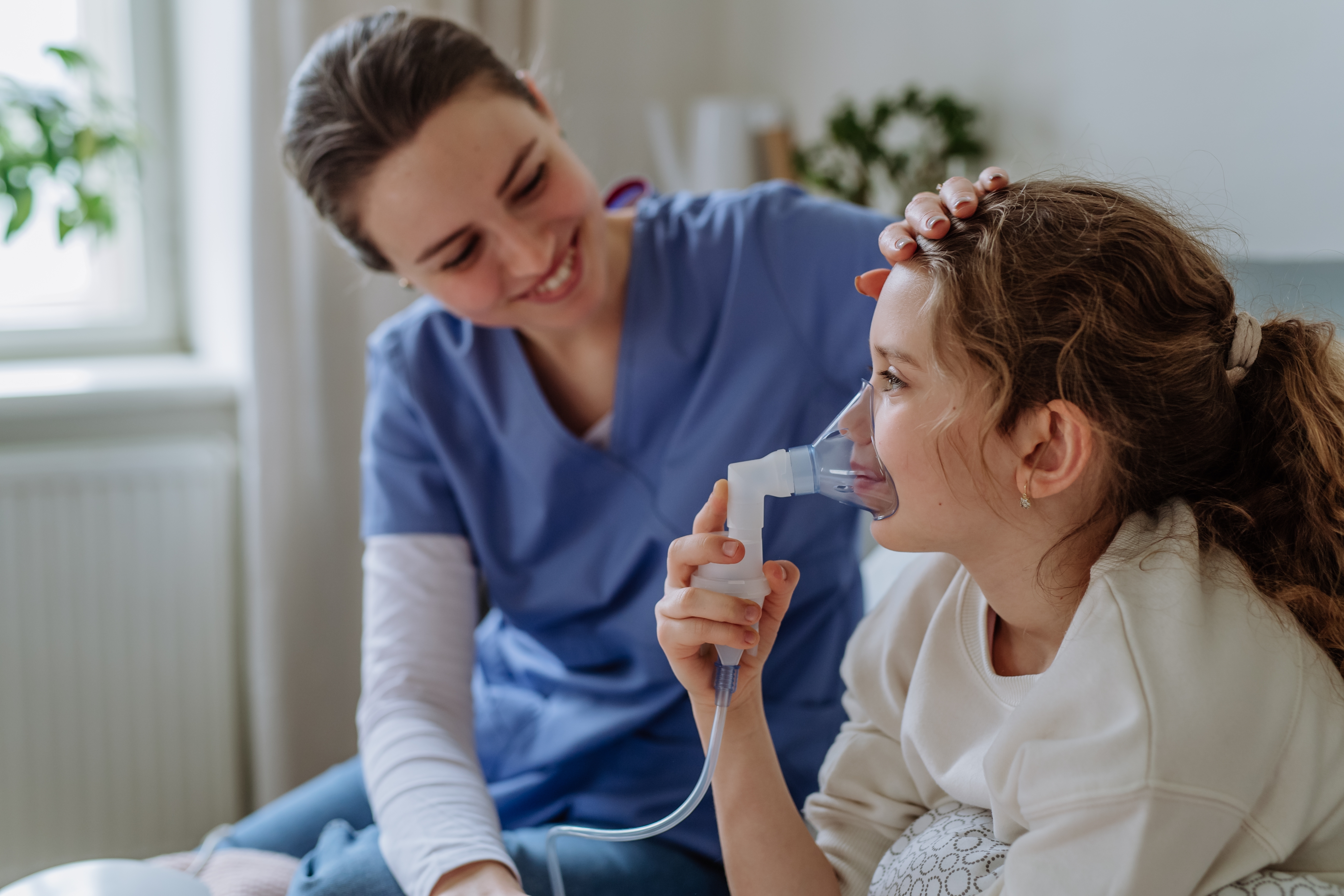 Nurse taking a little girl's temperature